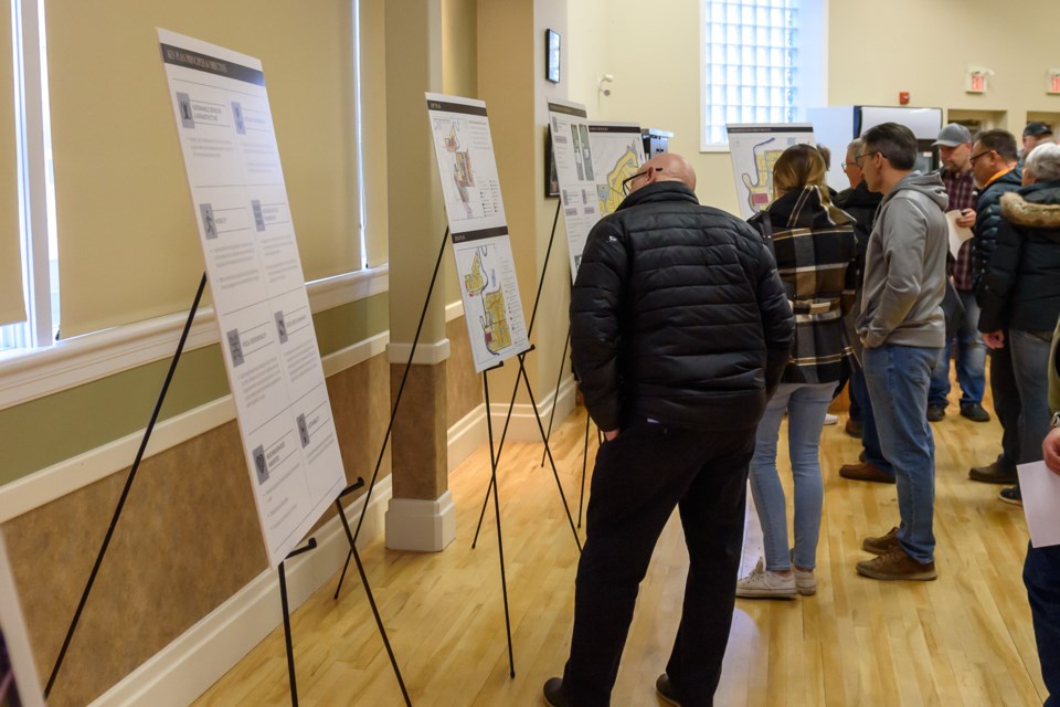 People view information at an open house for Highfield Ranch & Rowland Acres at the Highwood Centre in High River on March 19.