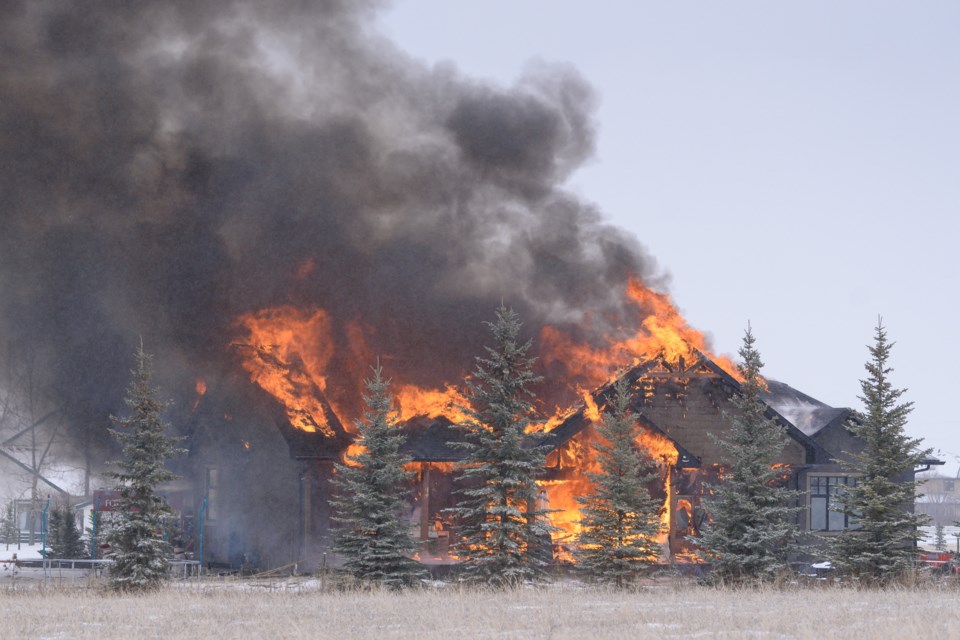 Flames engulf a home on 552 Street W. near 265 Avenue in Foothills County on March 20.