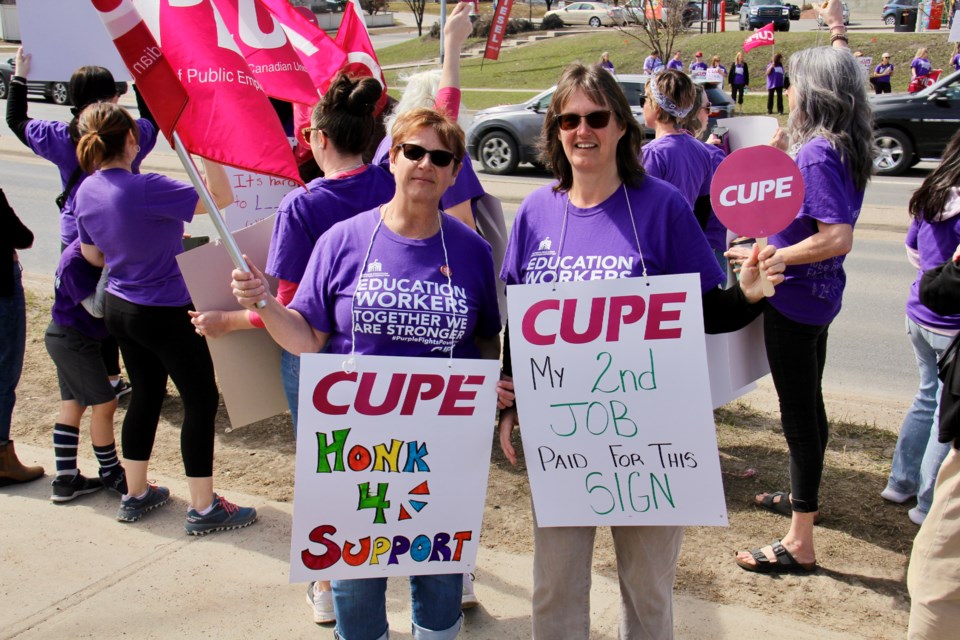 "We're determined that education workers are gonna get a better deal," said CUPE 5040 president Lesley Cole, pictured (left) alongside vice-president Bernadette De Bruin at a rally in Okotoks on April 13.