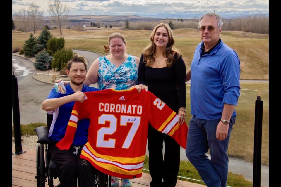 Stephen and Shannon Wong, left, hold up their signed Matthew Coronato jersey alongside D'Arcy Ranch Golf Club employee Victoria Ross and general manager Tim Watt.