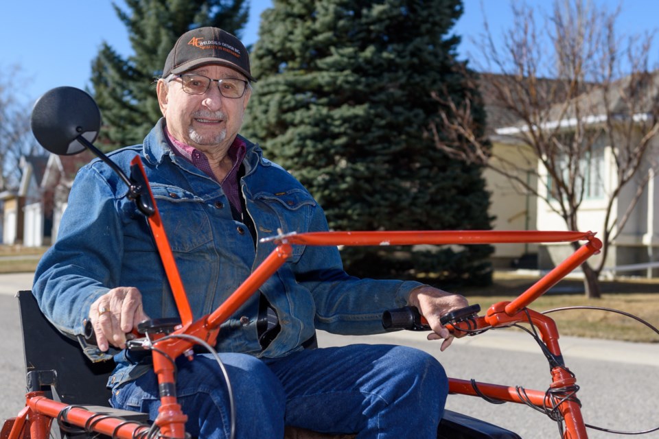 Edwin Bronsch sits on one of his off-road electric wheelchairs in High River on April 10. Bronsch built two of the machines after a back injury made it difficult for him to get out into the bush.
