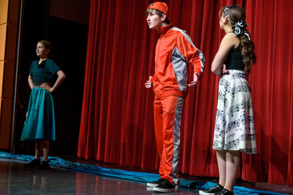 From left to right, Serena Caffrey, as Counterpoint, Sebastian Bor, as Rad, and Sana Hage, as Mel, perform “Musicville” at Holy Trinity Academy in Okotoks on April 19. The play represents the first musical put on by the St. Francis Fine Arts Department.