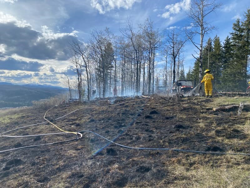 Firefighters work at a wildfire near Priddis, in Foothills County, on April 27.