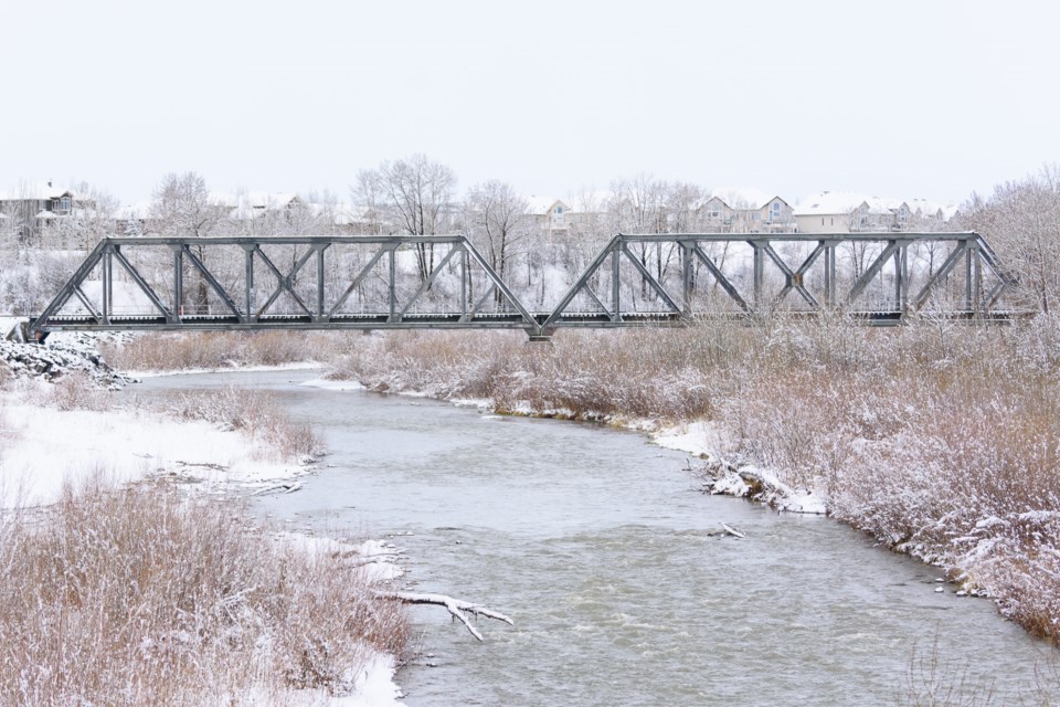 The river valley near the CPKC rail bridge is blanketed with snow following a spring storm in Okotoks on April 30.