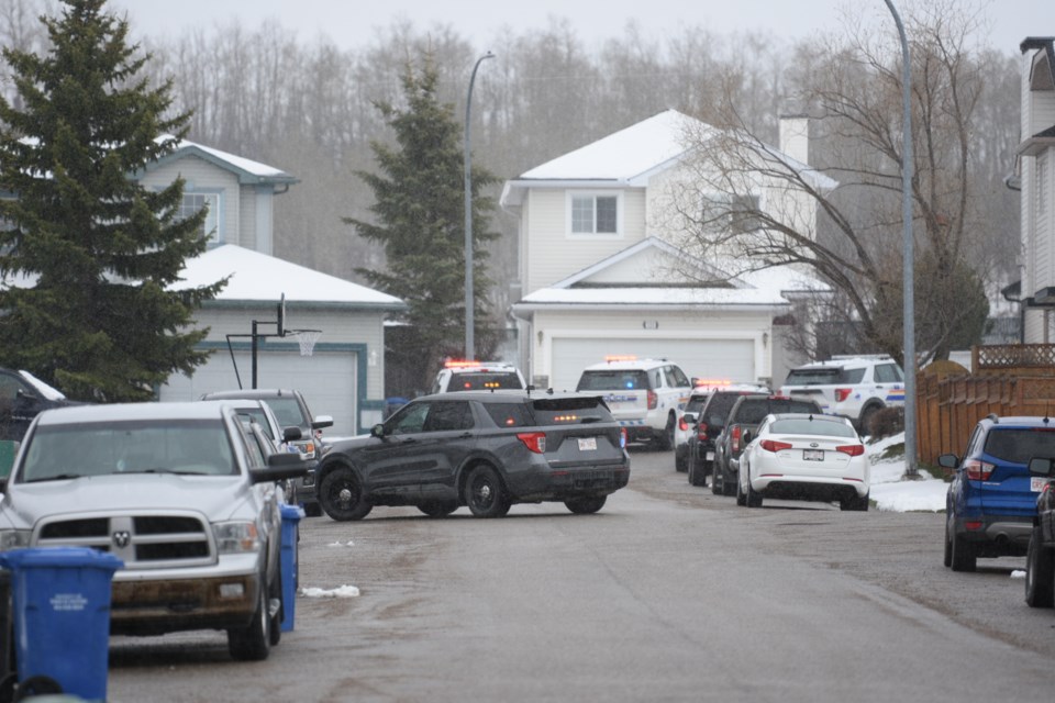 There is a large police presence at a home on Sheep River Court in Okotoks on May 1.