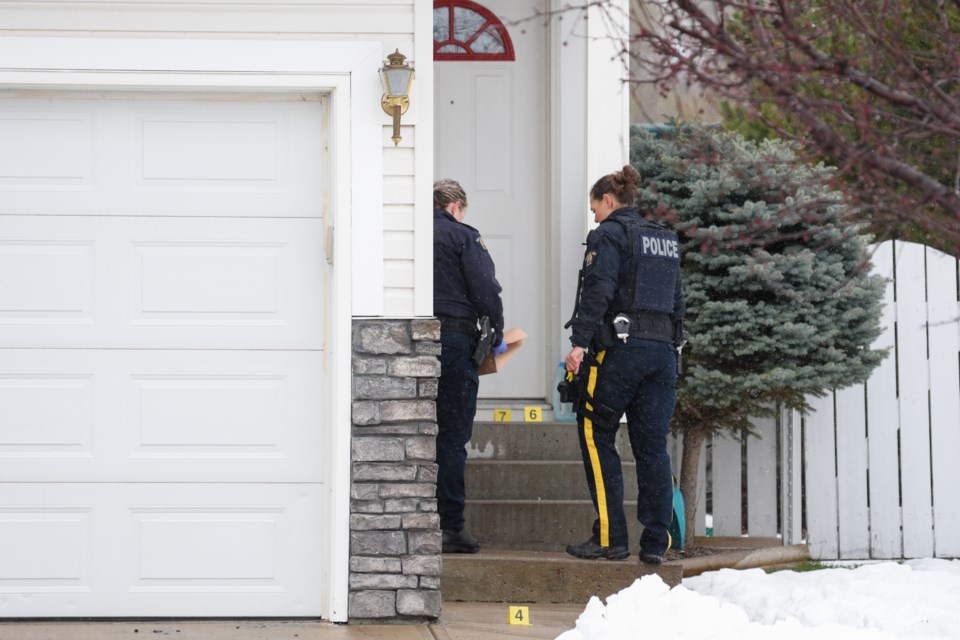RCMP officers investigate a reported shooting on Sheep River Court Okotoks on May 1.