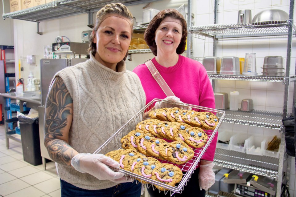 Baby It's Cold Outside volunteers Tamara Boivin (left) and Julie Dufresne show off a batch of smile cookies.