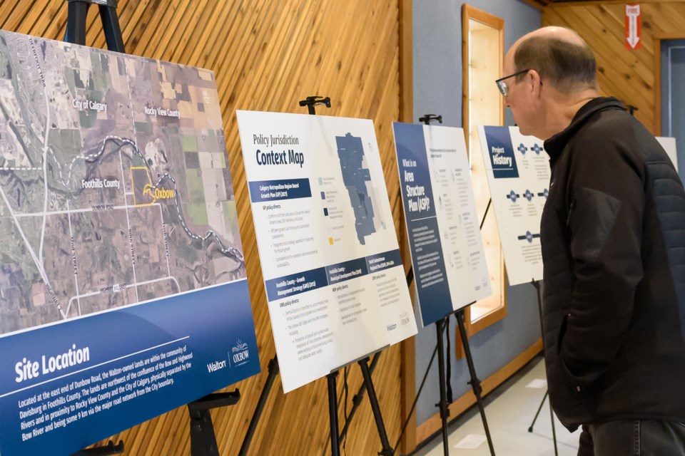 An attendee views an information board at an open house for the Oxbow Area Structure Plan that was held at the Davisburg Community Hall in Foothills County on May 7.