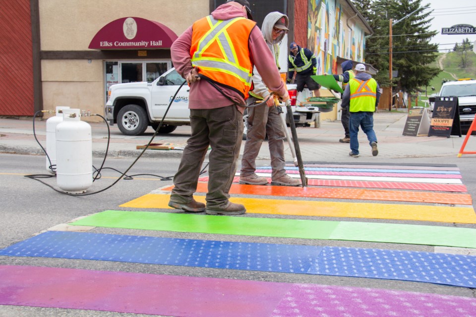 The Okotoks pride crosswalk, located at the intersection of Elizabeth Street and Elk Avenue, is repainted.