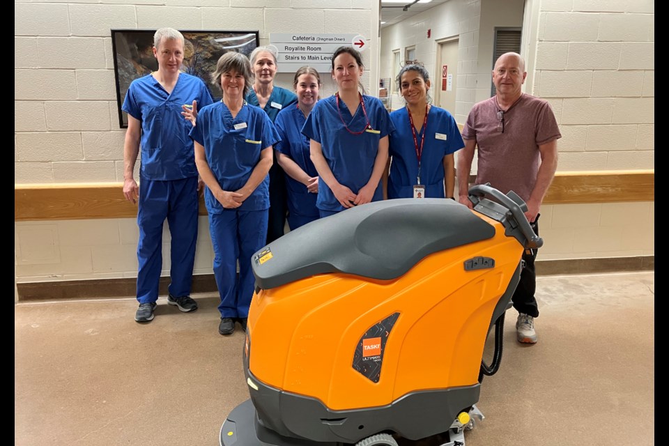Staff at Oilfields General Hospital gather around the new Taski Auto Scrubber. 