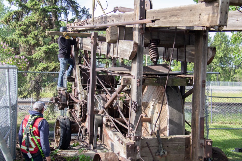 Okotoks' historic oil rig is prepared for transport on the morning of June 19. Work went from approximately 6 to 10 a.m.