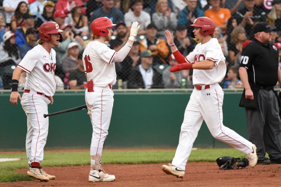 The Okotoks Dawgs' Logan Grant celebrates a run scored during the six-run second inning in the 7-4 win over the Moose Jaw Miller Express in Game 1 of the Western Canadian Baseball League Final at Seaman Stadium in Okotoks on Aug. 15.