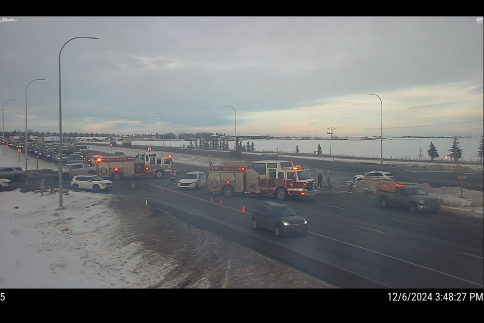 A screenshot from a traffic camera shows emergency crews at a two-vehicle accident on Hwy. 2 and 370 Avenue near Okotoks on Dec. 5.