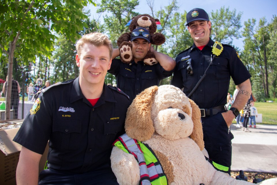 Okotoks firefighters pose with teddy bears at the Okotoks Teddy Bear Picnic on July 4 in Ethel Tucker Centennial Park.