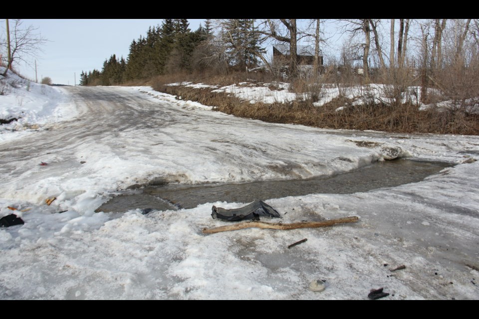 The pit is located at a crossing near Millarville, and the remains of several car wrecks are scattered along it.