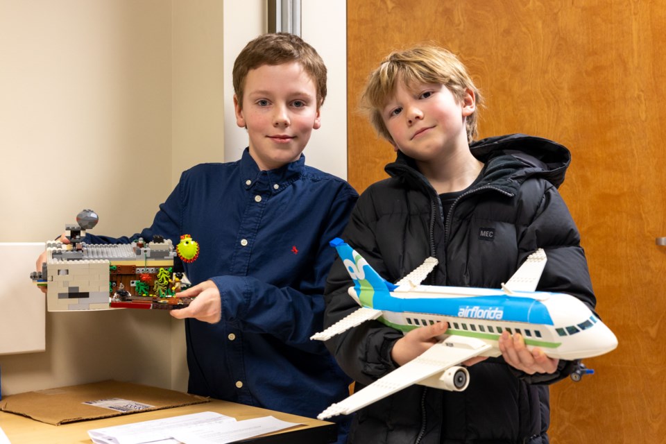 Michael Dunbar (left) and Francis Steven Leeder pose for a photo with their creations during the Sheep River Library's Lego contest on Feb. 1.