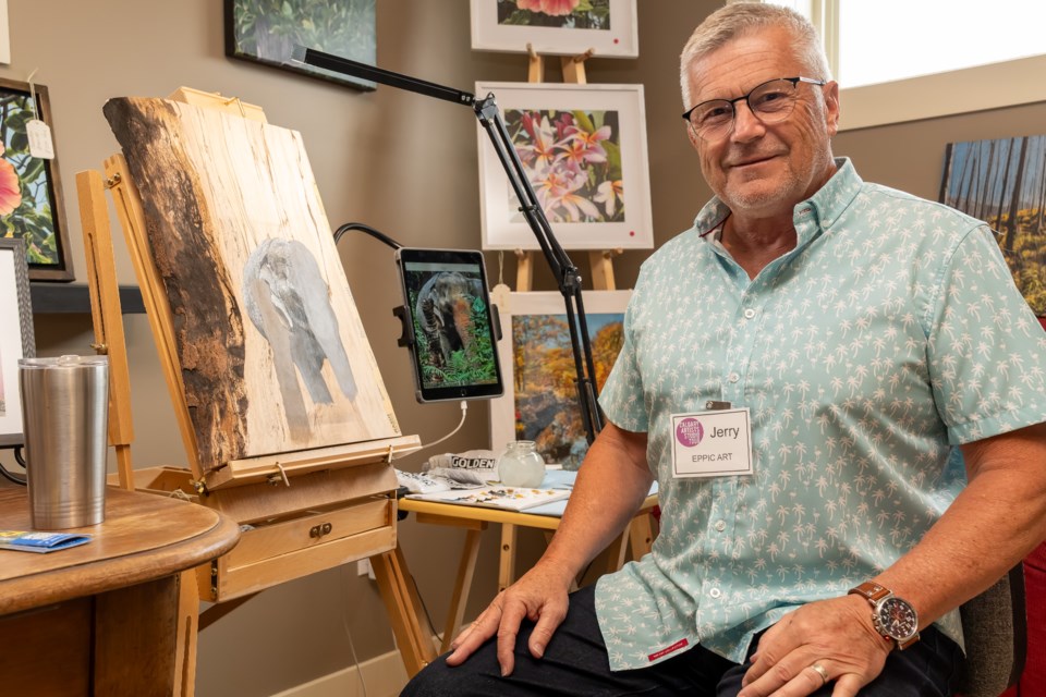 Jerry Epp poses with a painting he is working during the Calgary Artists Studio Tour on May 2.