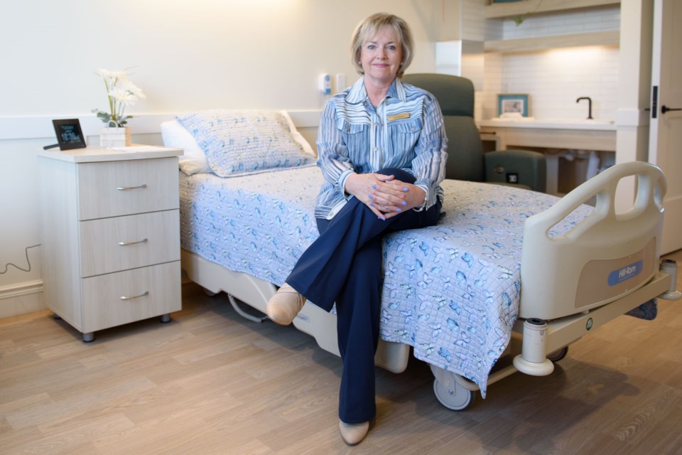 June Diment, board chair of the Foothills Country Hospice Society, sits in one of the new patient rooms built as part of an expansion to the Foothill County Hospice near Okotoks on May 20.