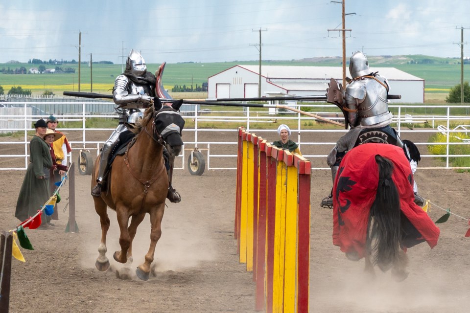 A rider from the Society of Tilt and Lance Cavalry makes contact and breaks his lance at the High River Medieval Faire on June 28.