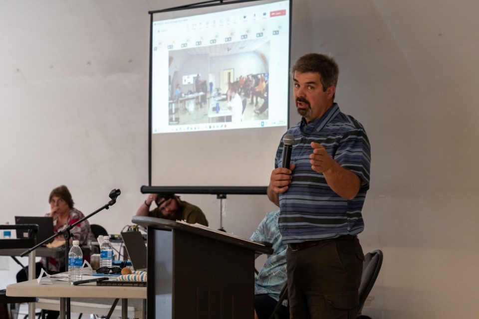 Diamond Valley Mayor Barry Crane responds to a resident's comment at the Colts Crossing public hearing at the Flare ’n Derrick Community Hall on July 16.