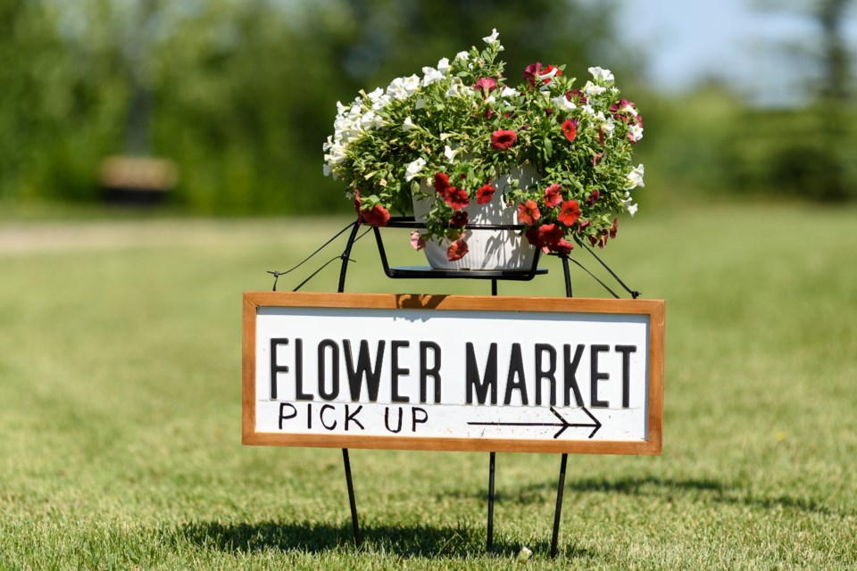 A sign directs clients to pick up their fresh-cut bouquets at the Floriculture Flower Farm on July 22.