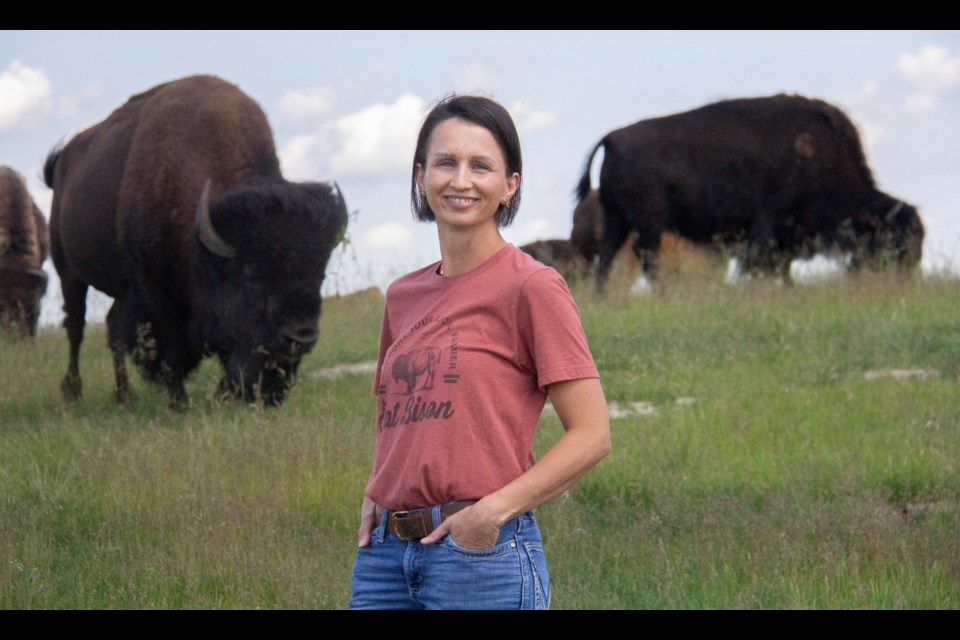 Jennifer Duckering poses with a few of her bison at the 1907 Bison ranch southwest of High River on July 4. 