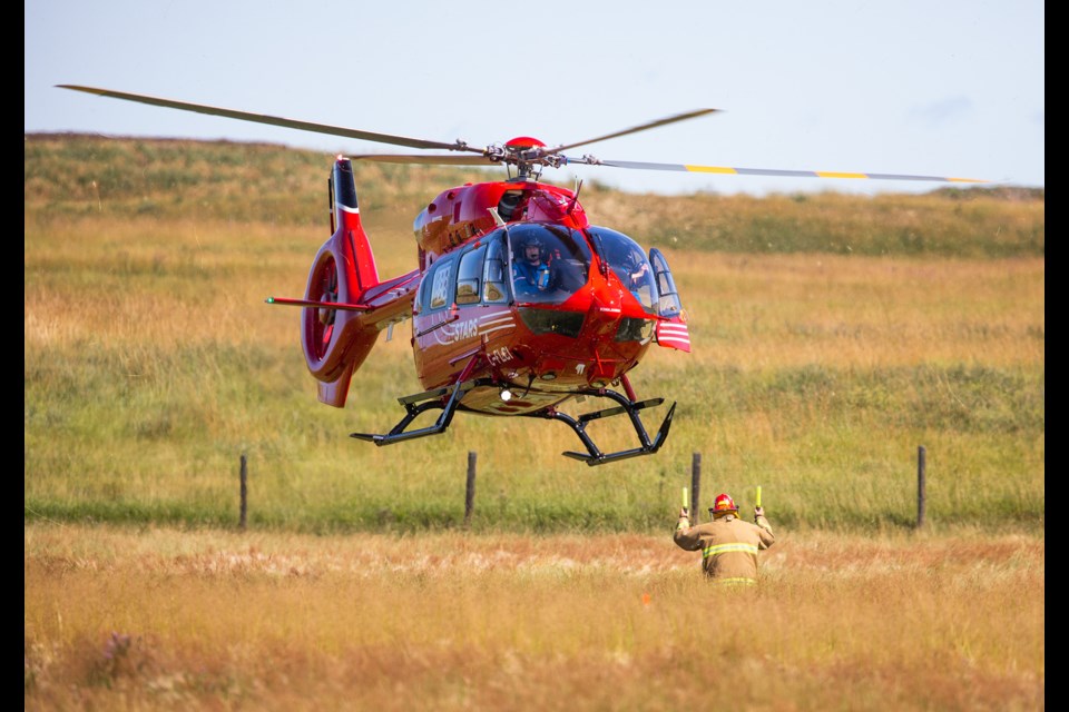 STARS Air Ambulance's new Airbus H145 helicopter lands at a 2019 incident near Black Diamond. As the medevac service has been unable to land at the Oilfields Hospital heliport, the Alberta government has announced $1 million for upgrades. (File photo Brent Calver/OkotoksTODAY)