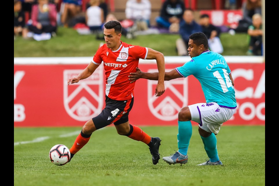 Cavalry FC defender Dominick Zator battles with Pacific FC midfielder Terran Campbell at Spruce Meadows in 2019. (BRENT CALVER/Western Wheel)