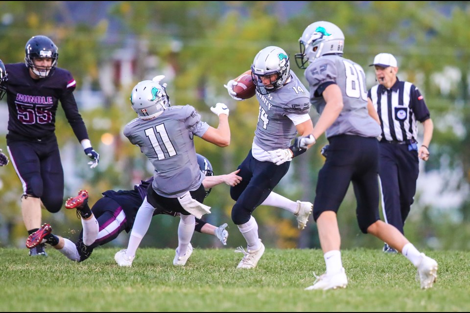 HTA Knight Noah Gutek makes a catch in traffic with younger brothers Jack Gutek (11) and Luke Gutek (80) nearby during the 41-0 win over Rundle College, Sept. 6 at Knights field. (BRENT CALVER/Western Wheel)