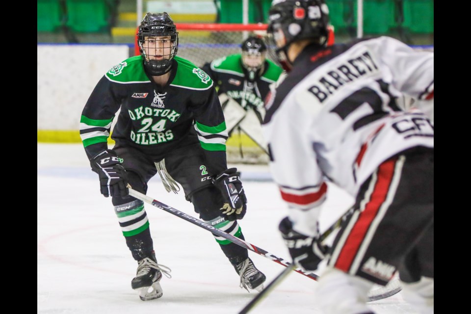 Okotoks Bow Mark Oilers forward Liam Watkins chases down Airdrie CFR Bisons defenceman Will Barrett at Pason Centennial Arena on Nov. 7. (BRENT CALVER/Western Wheel)