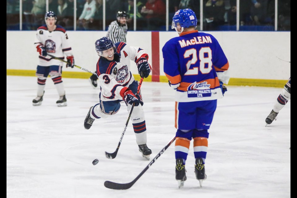 Okotoks Bisons defenceman Mitch Wolfe shoots past High River Flyers forward Logan MacLean at the Bob Snodgrass Arena on Nov. 29. Wolfe has been selected to play in the Heritage Junior Hockey League all-star game. (BRENT CALVER/Western Wheel)