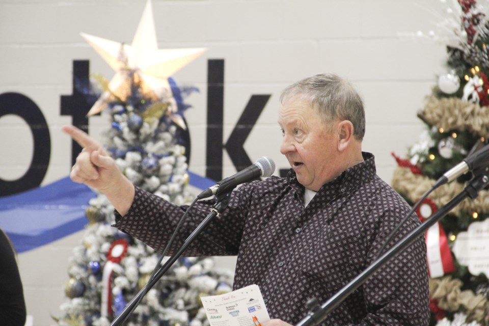 Dave Smith calls out a bid during the live auction for Avenue of Trees on Dec. 14.