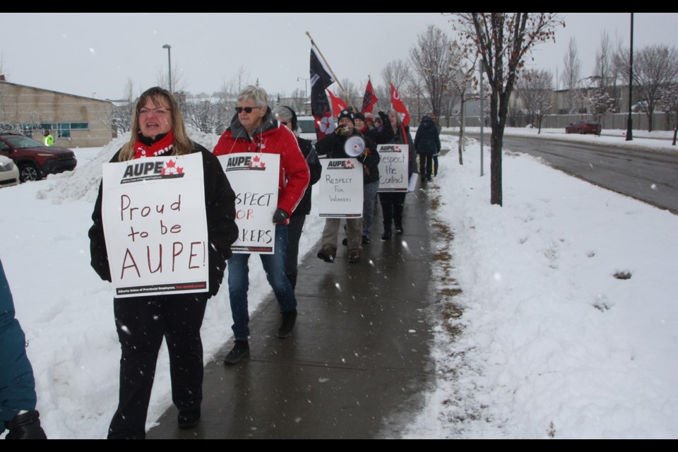Karen Weirs, a vice-president with the Alberta Union of Provincial Employees, leads a rally against the Alberta government's proposed cuts to health-care. 
