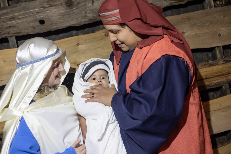 Daniel and Gabrielle Carton play the part of Mary and Joseph with their son Lachlan as Jesus in the live nativity at St. James Parish on Dec. 14. (BRENT CALVER/Western Wheel)