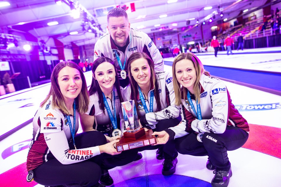 Team Walker lead Nadine Scotland, second Taylor McDonald, third Kate Cameron, skip Laura Walker and coach Brian Chick sport their gold medals and trophy after winning the 2020 Alberta Scotties Tournament of Hearts at Murray Arena on Jan. 26. (Brent Calver/Western Wheel)