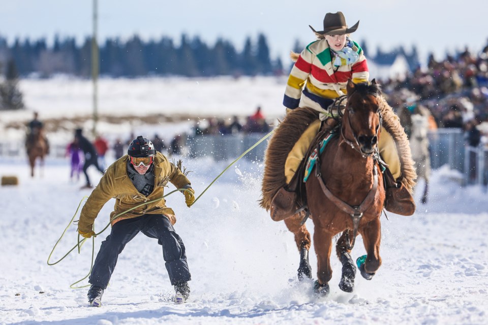 Jason Melnyk is pulled by Hailey Stewart in the relay during Skijordue at the Millarville Ag Society on Feb. 22. (Brent Calver/Western Wheel)
