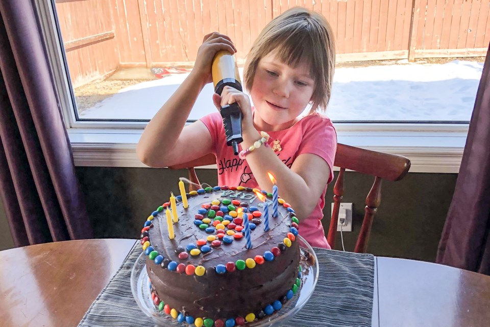 Clara Rees uses a balloon inflater to blow out the candles on her birthday cake. (Photo submitted/Stephanie Rees)