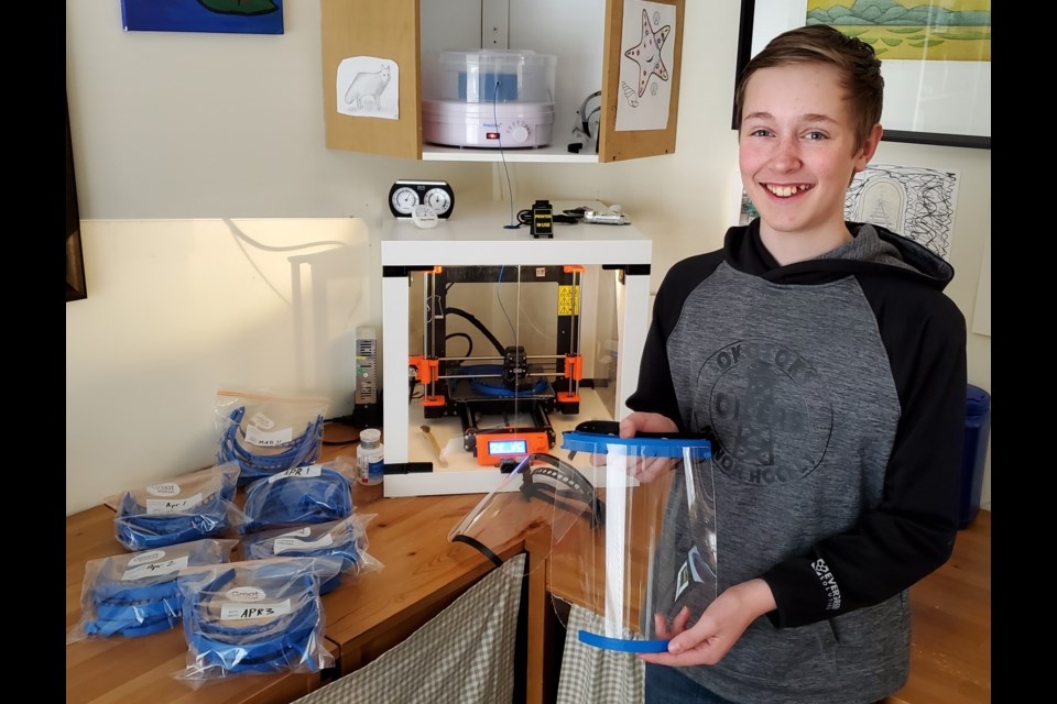 Owen Plumb, 13, of Okotoks, has helped make more than 100 face-shields, which he hopes to distribute to health-care workers in the Foothills community. (Photo submitted)