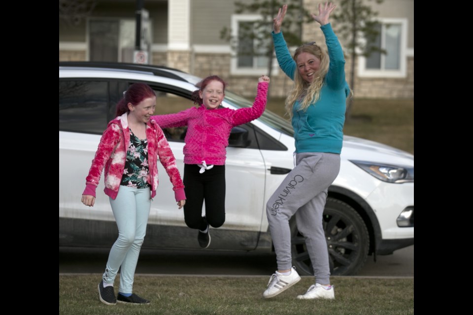 Hailey, Kya and mom Naomi Pretty dance and cheer for the staff at the Okotoks Health and Wellness Centre on May 1 as part of First Responders Day festivities. 