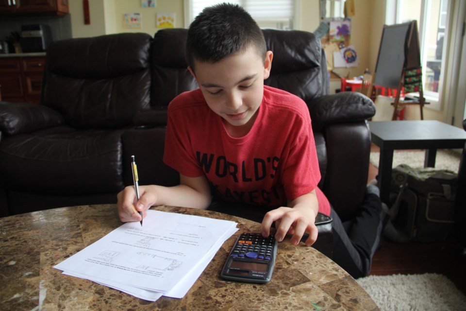 Christian works at his math on May 22.