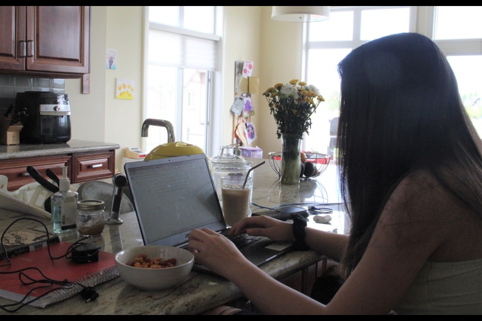 Alyssa works on an English paper on June 3.