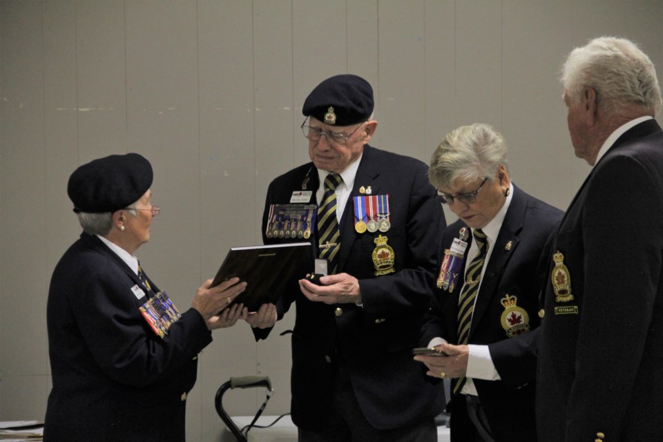 Malcolm Hughes received the Palm Leaf Award from District Commander Karen Bruens alongside his wife, Jenny, and Cochrane Legion member John Ferguson on June 30. (Krista Conrad/Western Wheel)