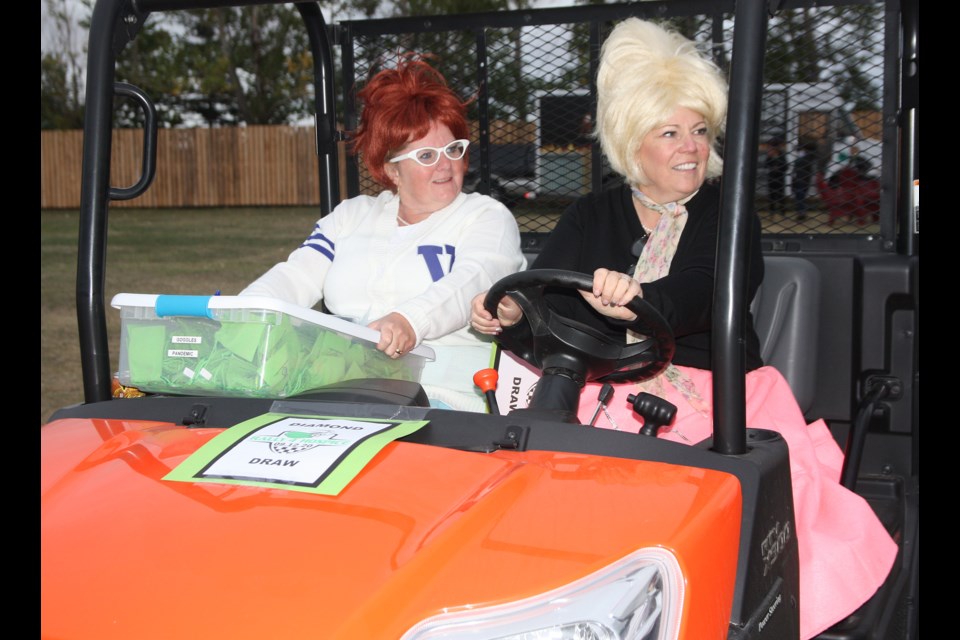 Michaela Clunie and Kim Schamp get dressed up to sell tickets for the diamond raffle at the Sunset Drive-in in High River as part of the Rally 4 Hospice on Sept. 12. (Bruce Campbell/Western Wheel) 