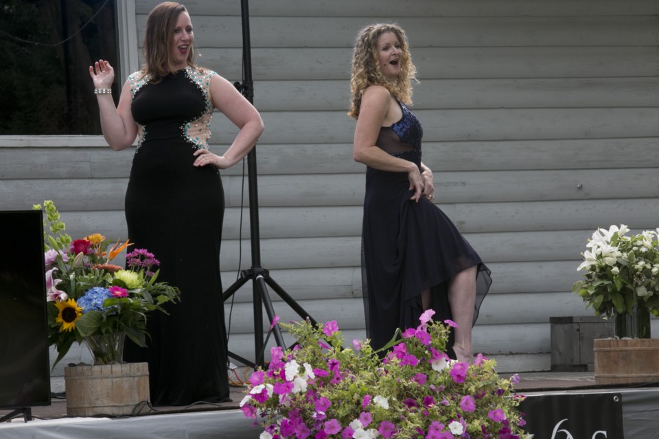 The Divas Opera, Kathleen Morrison left, and Barbara King, flirt a bit during the whimsical The Merry Wives of Windsor at the duo's the Show Must Go On! outdoor performance in Okotoks on Sept. 13. 