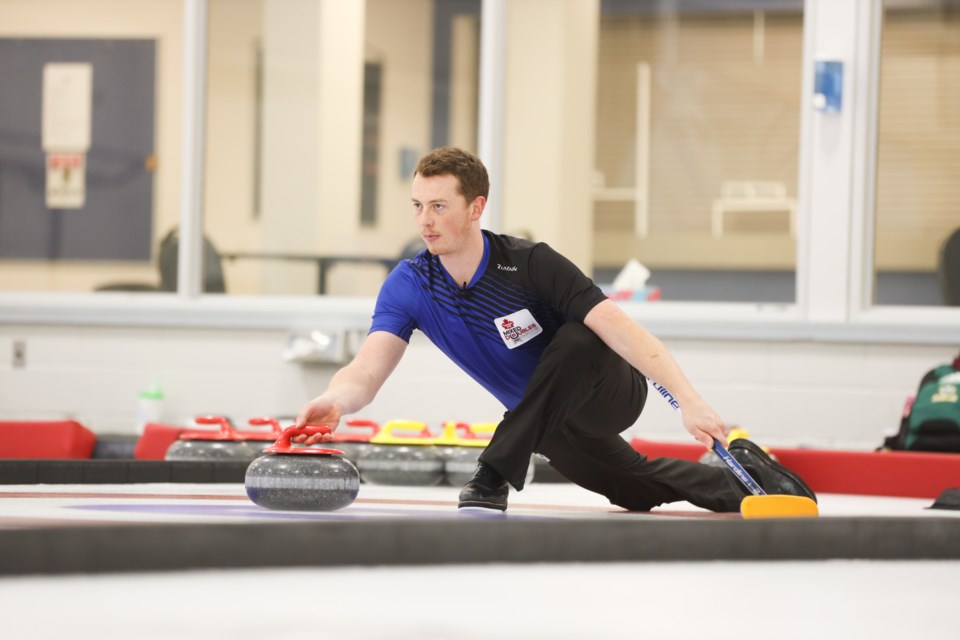 Kyler Kleibrink throws during finals for the WFG Okotoks Mixed Doubles Classic at the Okotoks Curling Club on Nov. 1. (Brent Calver/Western Wheel)