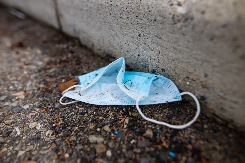A discarded medical mask lays in a parking lot in Okotoks on Oct. 29. (Brent Calver/Western Wheel)