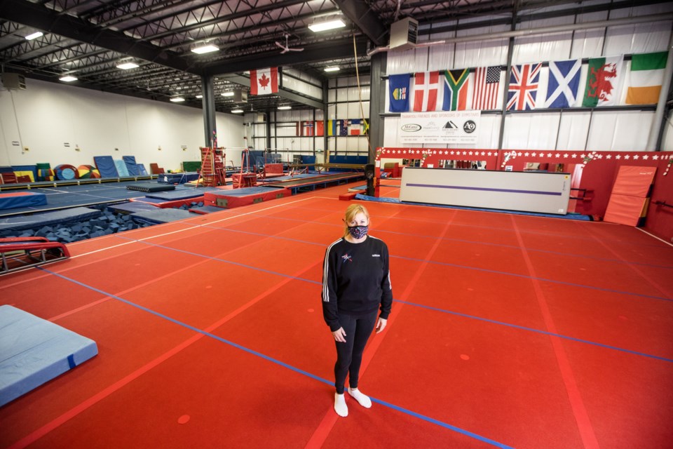 Karen Sim, owner of Foothills GymStars, poses for a photo in her gymnastics gym on Nov. 22. Recent restrictions have been extended to include gymnastics, requiring them to cease all operations save for one-on-one training. (Brent Calver/Western Wheel)