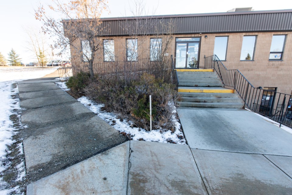 The worn stairs and wheelchair ramp at the front of the Black Diamond Municipal Centre on Nov. 18. Town administration has recommended to council that the stairs be rebuilt to code, including making the ramp longer. (Brent Calver/Western Wheel)