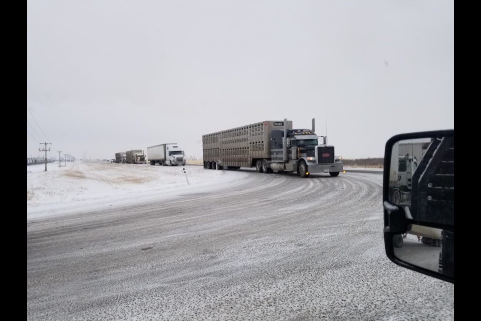 Trucks stack up on Highway 2A outside Cargill Meats and Abilds Industrial Park. Foothills County and area business owners are pushing for a solution to the safety issue. (Photo courtesy Jonathon Emsheimer)