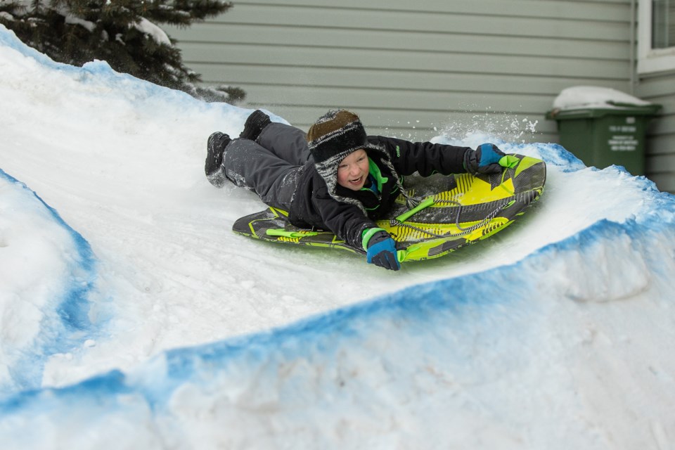 Owen Diggins, 6, flies down a front-yard toboggan hill dubbed Mount Crumpet on Dec. 29. His dad Kyle Diggins and neighbour Nevin Jones built the homemade hill on Christmas Eve after a Dec. 22 snowstorm that blanketed much of southern Alberta with between 20 and 40 centimetres of snow. (Brent Calver/Western Wheel)